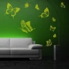 Butterfly sticker set 1135 - Living room arrangement. Green wall with yellow butterflies next to a gray sofa.