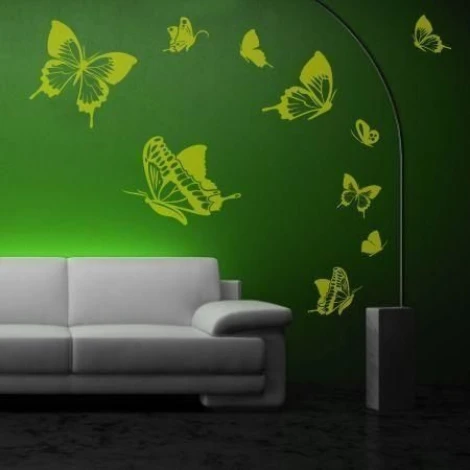 Butterfly sticker set 1135 - Living room arrangement. Green wall with yellow butterflies next to a gray sofa.