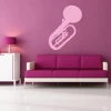 French horn sticker 1615 in a stylish arrangement on a pink wall of a modern living room, adding elegance.