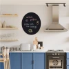 Round chalkboard for kitchen decor. Blue-toned walls with modern furniture and appliances.