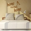 Sticker 03X 20 home sweet home 1720 - Bedroom decor with light-colored walls and striped pillow bed.