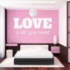 Sticker 03X 24 love is all you need 1723 - Bedroom decor with pink walls and white and black furniture.