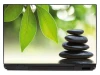 Zen garden laptop sticker 0052 - Graphic design with green leaves and stacked stones on a blurred green background.