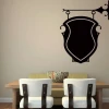Chalk sticker ornament 030 - Dining room setup with light walls, wooden table, and chairs with light upholstery.