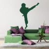 Sticker 03X 08 karate 1862 - Living room setup with light walls and a green sofa with pillows in various shades.