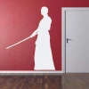 Sticker 03X 22 martial arts 1864 - Graphic design. White figure holding a sword on a red background.