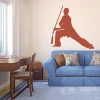 Sticker 03X 22 martial arts 1865 - Living room setup. Light-colored walls, blue sofa with cushions.