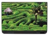 Laptop sticker P167 - Graphic design featuring green shrubs creating wavy patterns with a gazebo in the background.