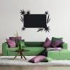 Chalk sticker leaves 090 - Living room decor. Light-colored walls, green sofa with purple-hued cushions.