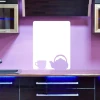 Dry-erase board featuring a cup and kettle design, set in a pink kitchen with modern dark furniture.