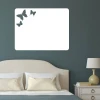 Dry-erase board butterflies 095 - Bedroom setup with dark walls and a bed featuring a light headboard.