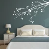 Sticker 03X 14 branch 1931 - Bedroom arrangement with dark walls and a bed featuring light bedding.