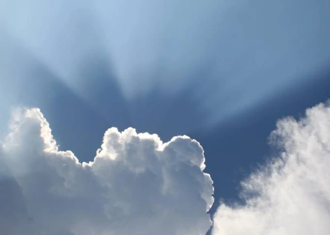 Dry-erase board sky clouds 228 - Graphic design featuring clouds against a sky with rays of light.