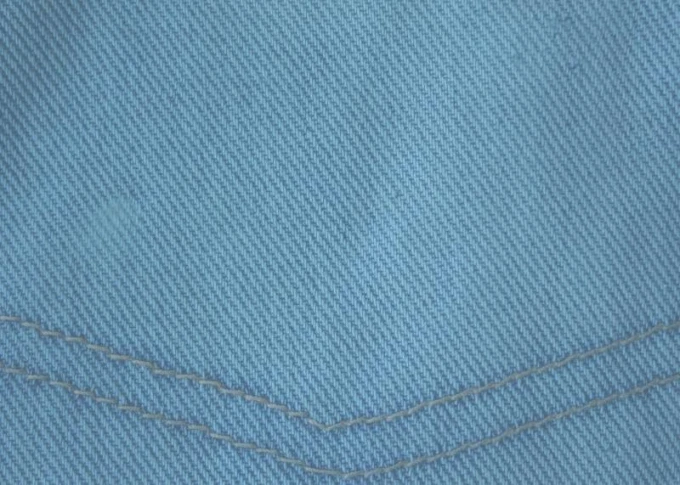 Magnetic dry-erase board in denim design, featuring blue fabric with visible stitching.