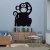 Chalkboard monkey sticker 195 - Room decor with light walls, natural wood furniture, and colorful cushions.