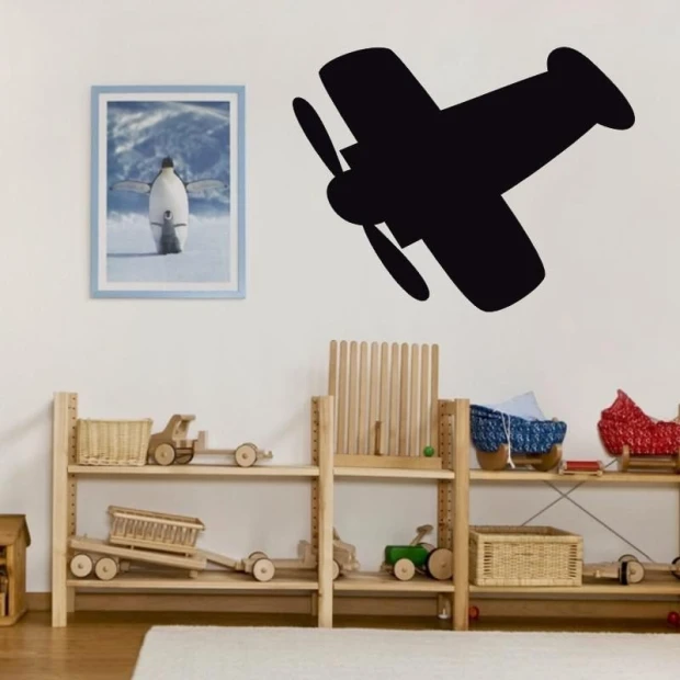 Chalkboard airplane sticker 212 - Decor for a child\'s room with light walls, wooden furniture, and toys.