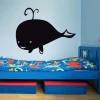 Chalkboard whale sticker 187 - Decor for a child\'s room. Light-colored walls, bed with colorful bedding.
