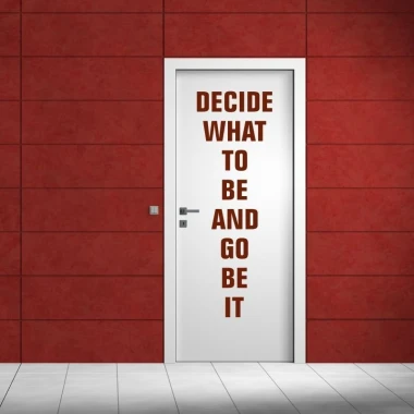 Sticker "decide what to be 1951" - hallway decor with red walls and white door featuring the text.