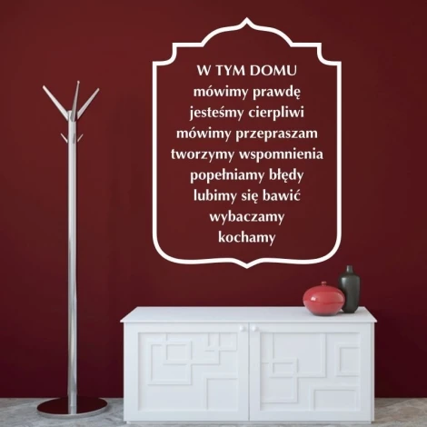 Sticker in this house 1942 - Living room decor. Dark red wall, white cabinet, and metal coat rack.