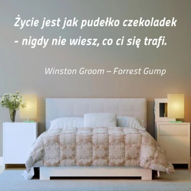 Sticker "Life is like a box of chocolates 1968" - Bedroom decor with light-colored walls and a bed with a gray coverlet.