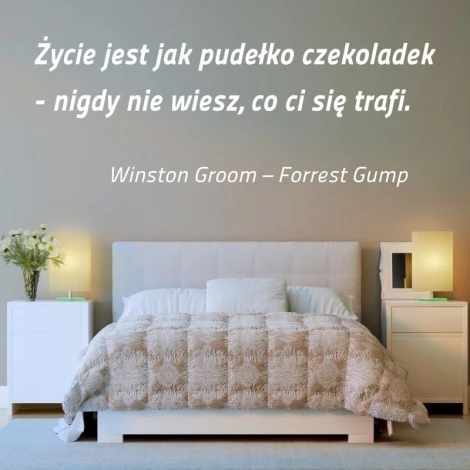 Sticker "Life is like a box of chocolates 1968" - Bedroom decor with light-colored walls and a bed with a gray coverlet.