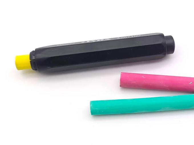Chalk holder - Graphic design. Simple cylindrical shape with a yellow tip and two colored chalks.