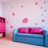 Ladybug stickers set 1974 - Decor in a child\'s room. Light-colored walls, furniture in shades of pink.