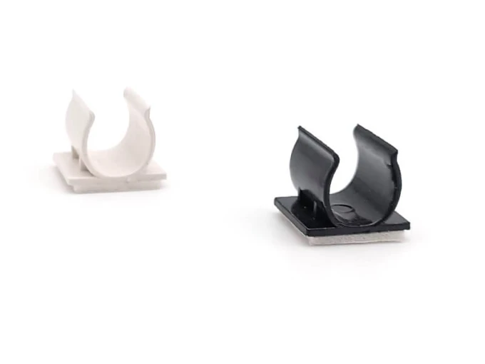 White C-shaped plastic holder for double-sided markers or pens with a graphic design.