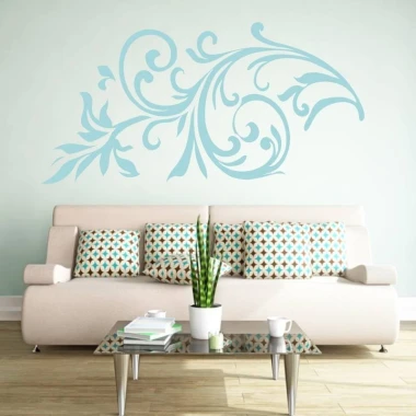 Floral wall sticker 2067 - Living room setup with a light-colored wall and a sofa with geometric patterned cushions.