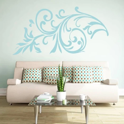 Floral wall sticker 2067 - Living room setup with a light-colored wall and a sofa with geometric patterned cushions.