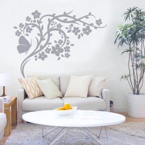 Butterfly branch decorative sticker 2121 - Living room decor with light walls and a bright sofa with cushions.