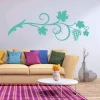 Decorative grapevine sticker 2127 - Living room setup with light-colored walls and a sofa with colorful cushions.