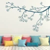 Branch sticker 2149 - Living room decor with light walls, wooden floor, and colorful cushions on the sofa.