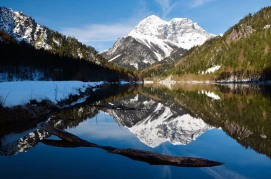 Wall mural of enchanting snowy mountains FP 1430 - Graphic design. Snowy peaks reflected in water under a bright sky.