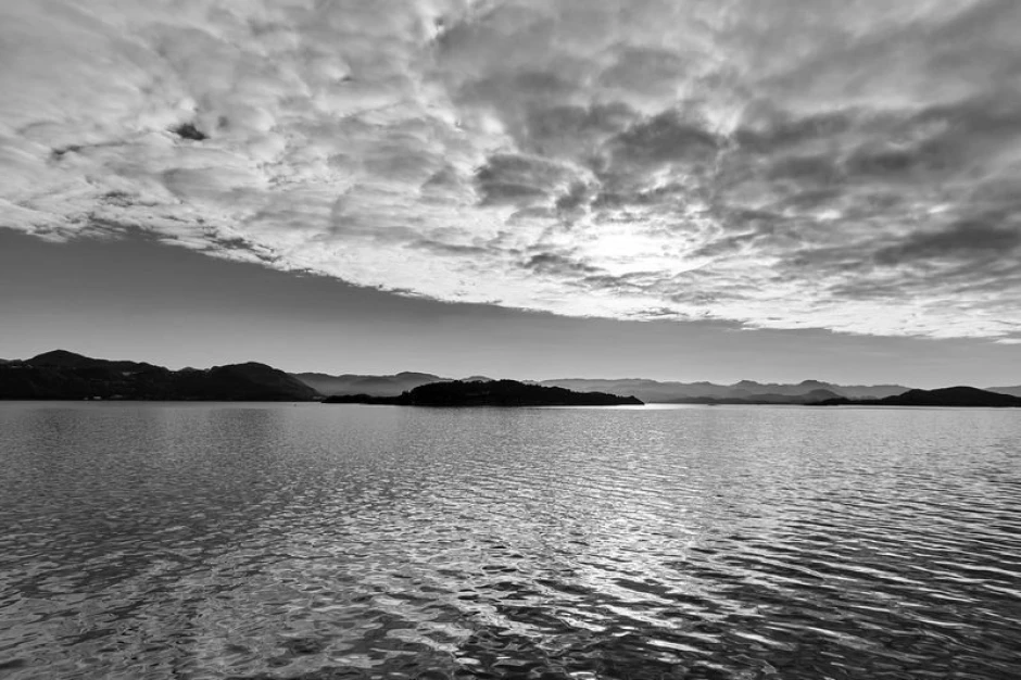 Wall mural of distant small islands FP 1414 - Graphic design. View of islands in water with clouds in the sky.