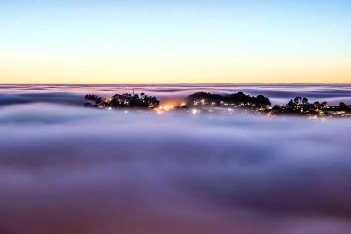 Wall mural of fog rising over the city FP 1517 - Graphic design. Fog softens the city\'s outlines, background visible.