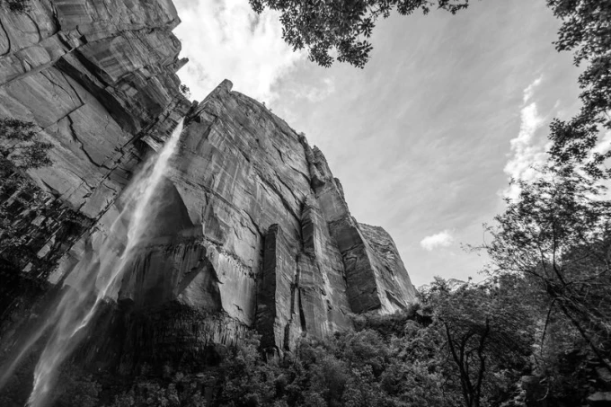Waterfall wall mural among red rocks FP 1622 - Graphic design. Water cascades from a high rock, surrounded by nature.