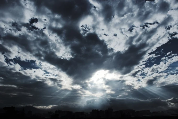 Wall mural of the sun breaking through clouds FP 1748 - Graphic pattern. Clouds in various shades of gray.