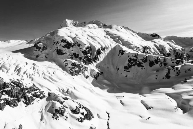 Wall mural fresh mountain snow FP 1738 - Graphic design. White snowy mountains with dark rocks in the valleys.