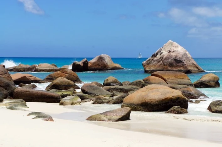 Wall mural of picturesque beach rocks FP 1901 - Graphic design featuring uniquely shaped rocks against blue water.