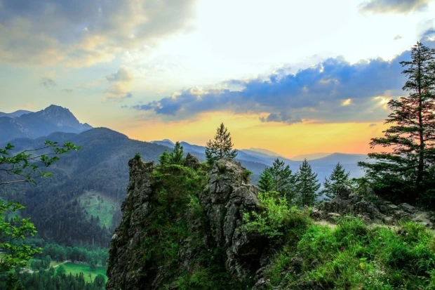 Wall mural featuring a beautiful mountain view FP 1946 - Graphic design with mountains, trees, clouds, and sunset.