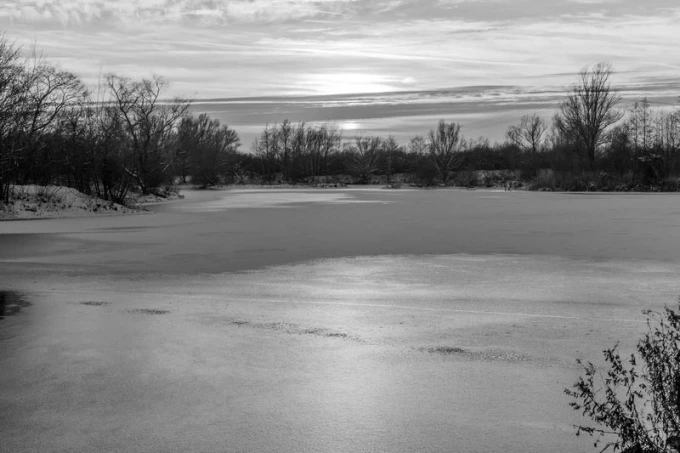 Wall mural of a sunset over a frozen lake FP 2016 - Graphic design. The image features a lake covered in ice.