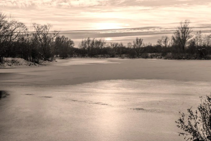Wall mural of a sunset over a frozen lake FP 2016 - Graphic design. Scene of a frozen lake.