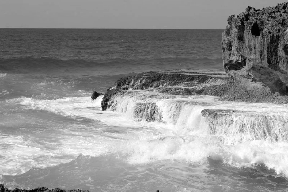 Azure water wallpaper with flowing water over rocks, featuring a graphic design with movement and various shades.