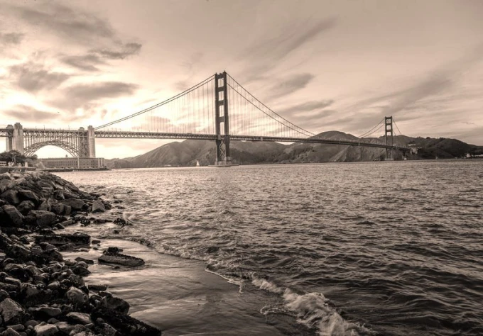 Red hanging bridge wall mural FP 2151 - Graphic design featuring a bridge with cables over water, mountains, and clouds in the background.
