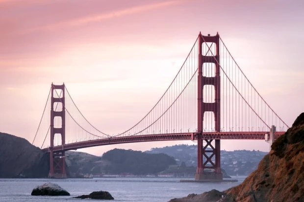 Wall mural of the Golden Gate Bridge FP 2197 - Graphic design. Red bridge against a sunset sky backdrop.
