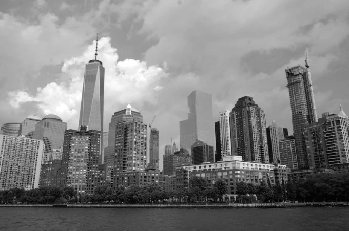 Cityscape wallpaper from a ship FP 2269 - Graphic design. Gray buildings in various shapes against a cloud backdrop.