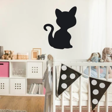 Chalkboard sticker of a black cat - perfect for a child\'s room with light-colored walls and white and pink furniture.