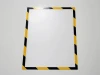 Black-yellow magnetic frame A4 - Graphic design. Simple rectangular frame with a black-yellow pattern on the edges.