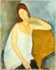 Reproduction of Jeanne Hebuterne by Amedeo Modigliani. Female figure in a white blouse with hand on chin.